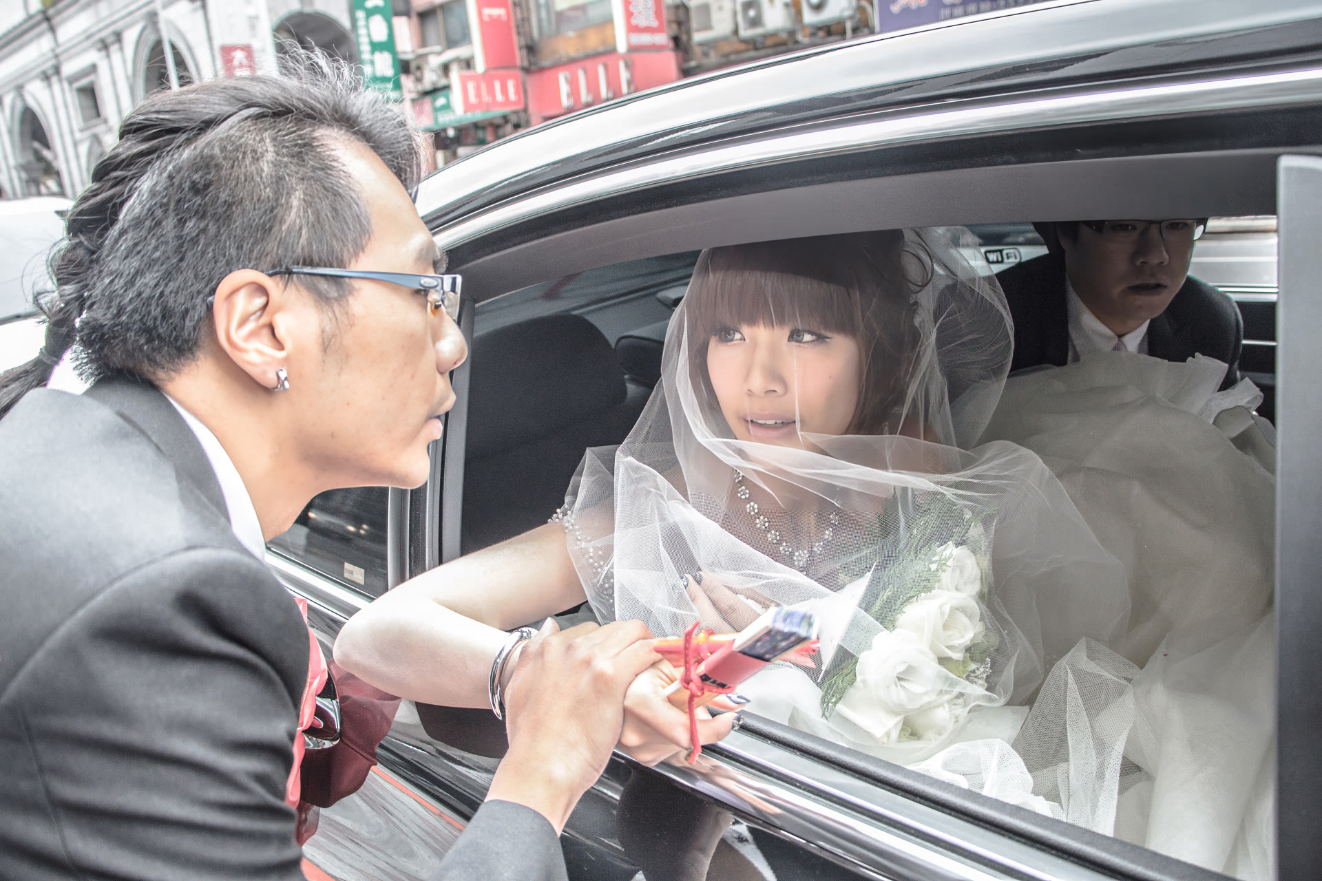 Bride in the car on her wedding day, seen through the open window