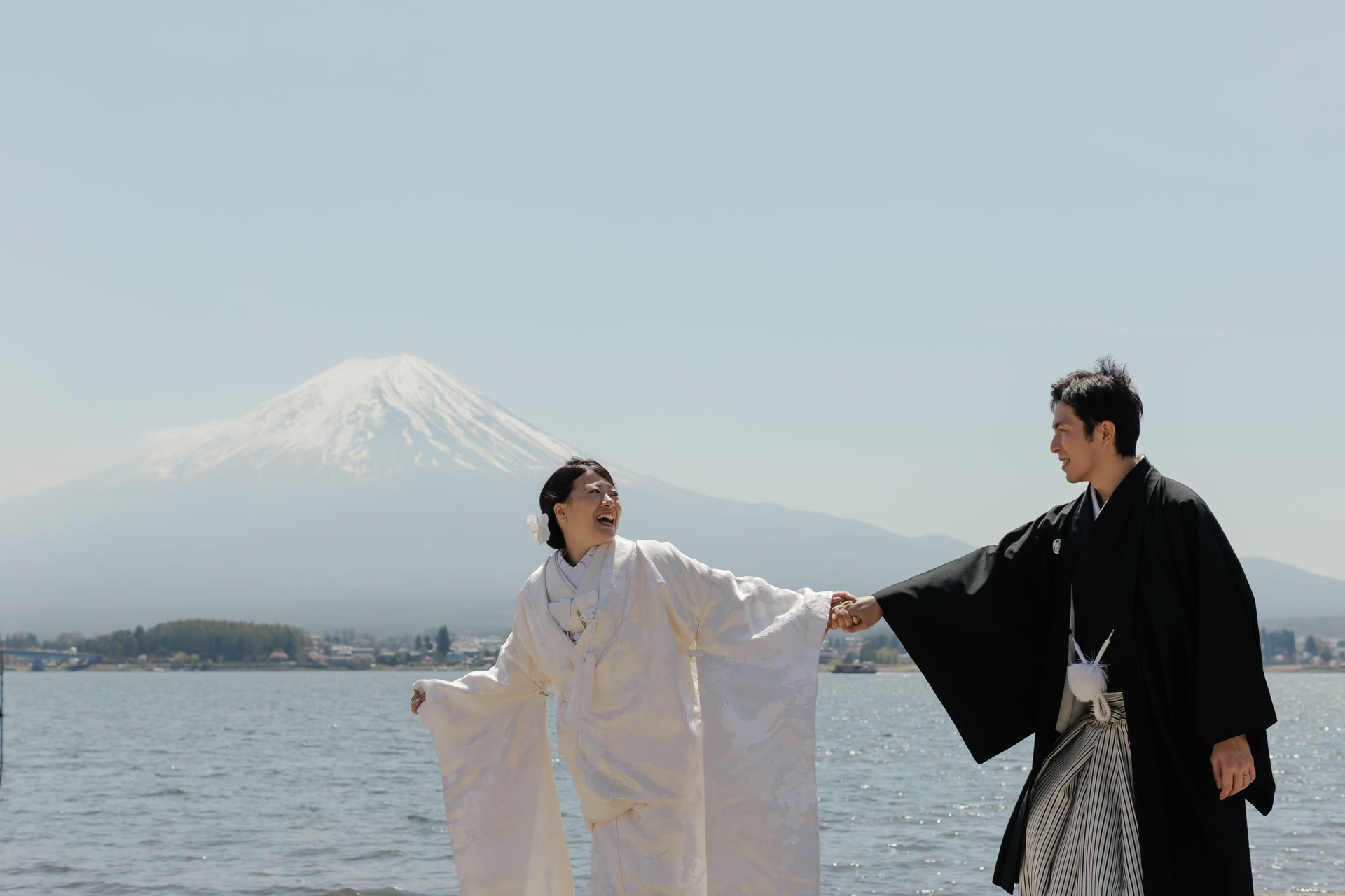Bride in shiromuku beside Lake Kawaguchi with Mt. Fuji behind