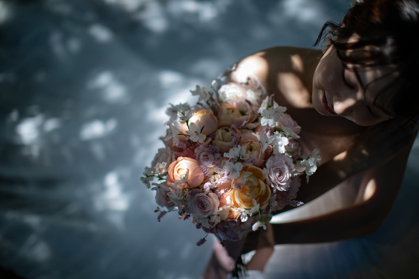 Bouquet held in dappled forest light in Okinawa
