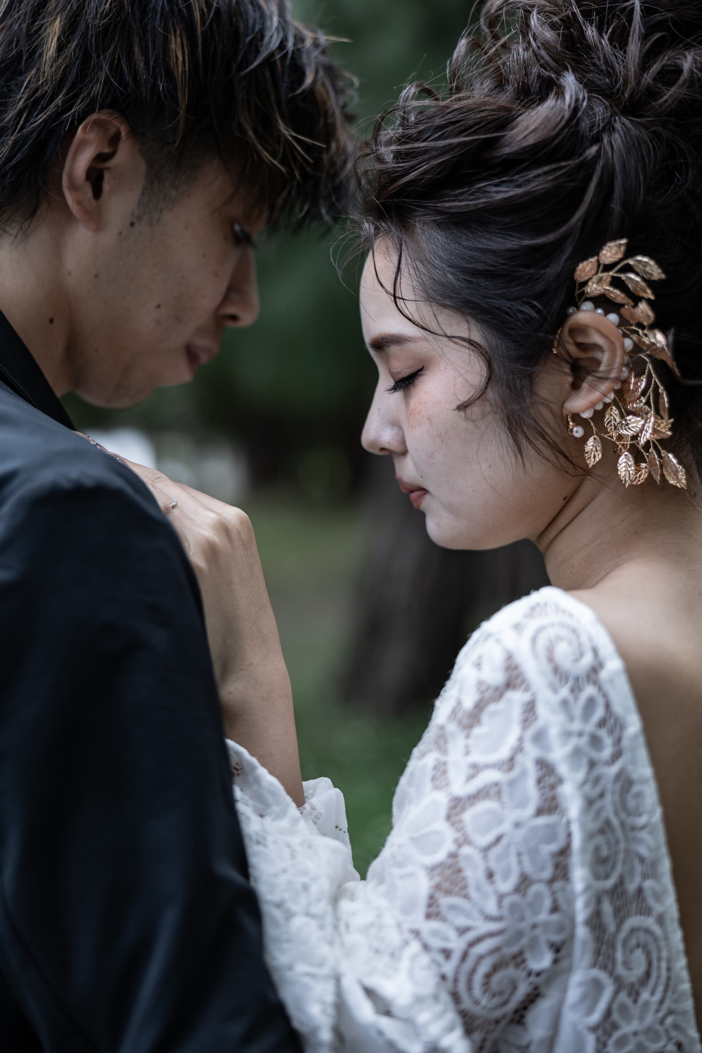 Couple close together, the bride's hair ornament in detail