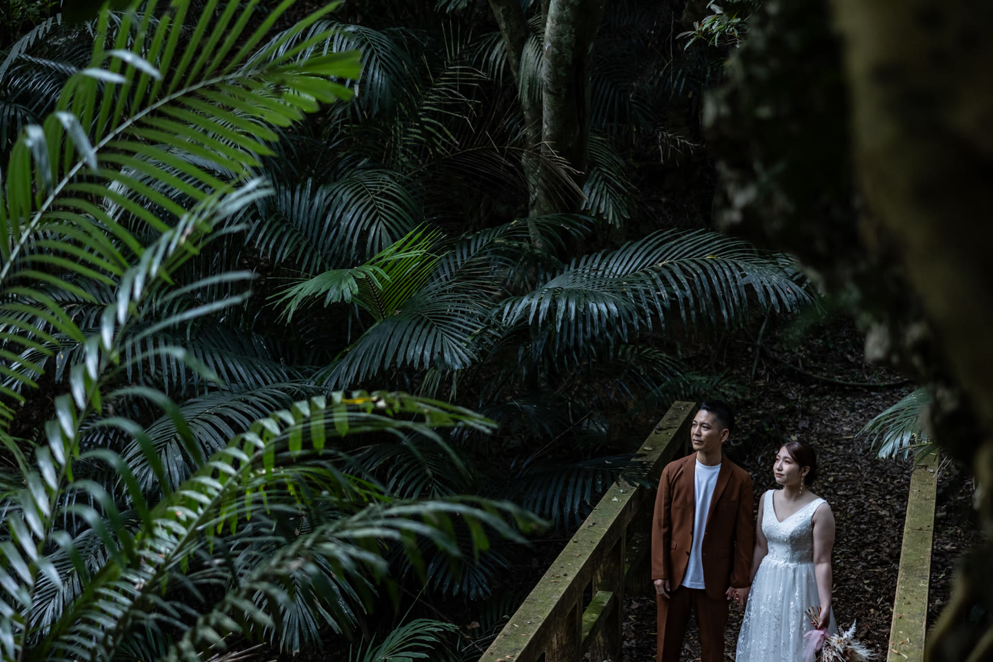 Couple on stone steps surrounded by cycads in Okinawa