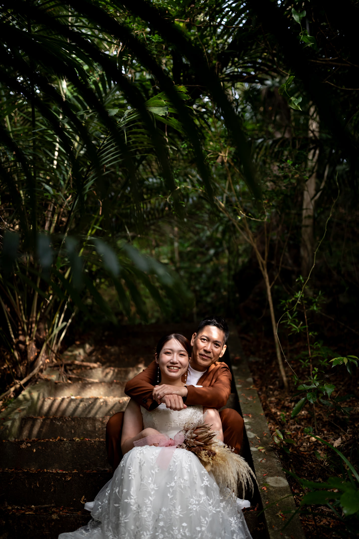 Couple standing in deep forest shade during an Okinawa pre-wedding shoot