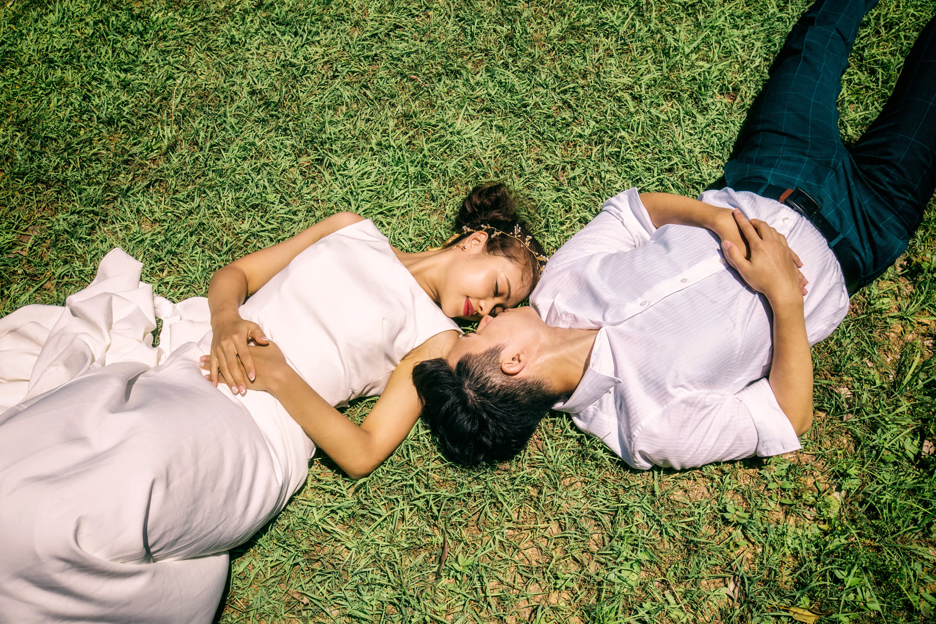 Couple lying on the grass together, photographed from above in Okinawa