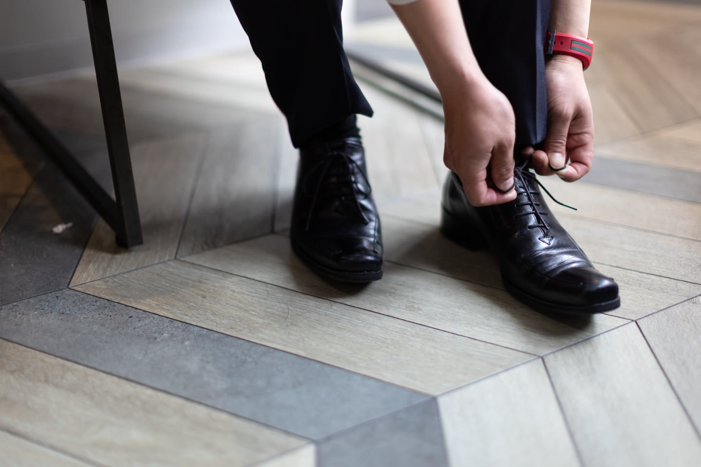 Groom's shoes being fastened before a pre-wedding photoshoot in Japan