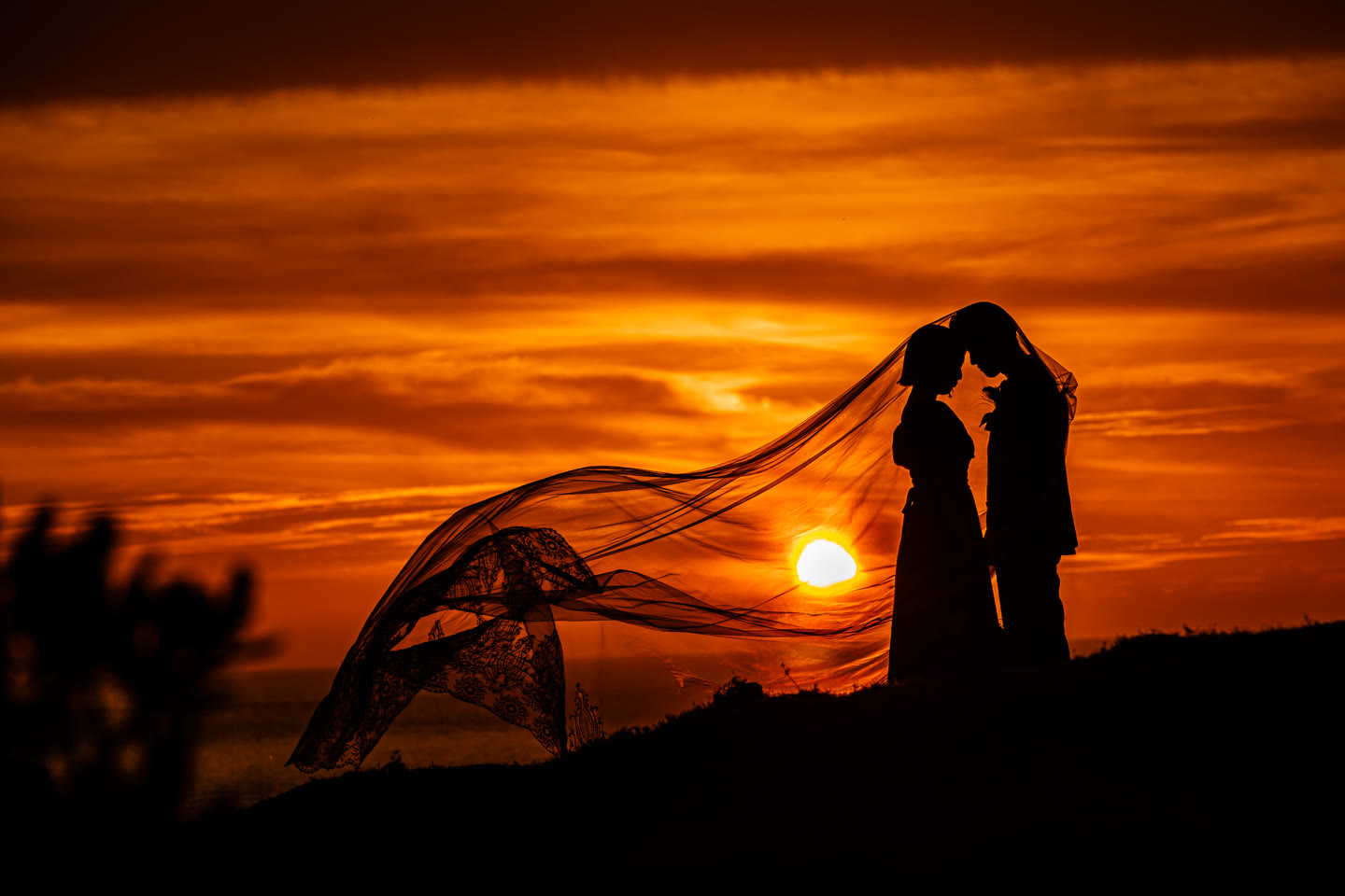 Veil catching the last of the sun as a couple stand together in Okinawa
