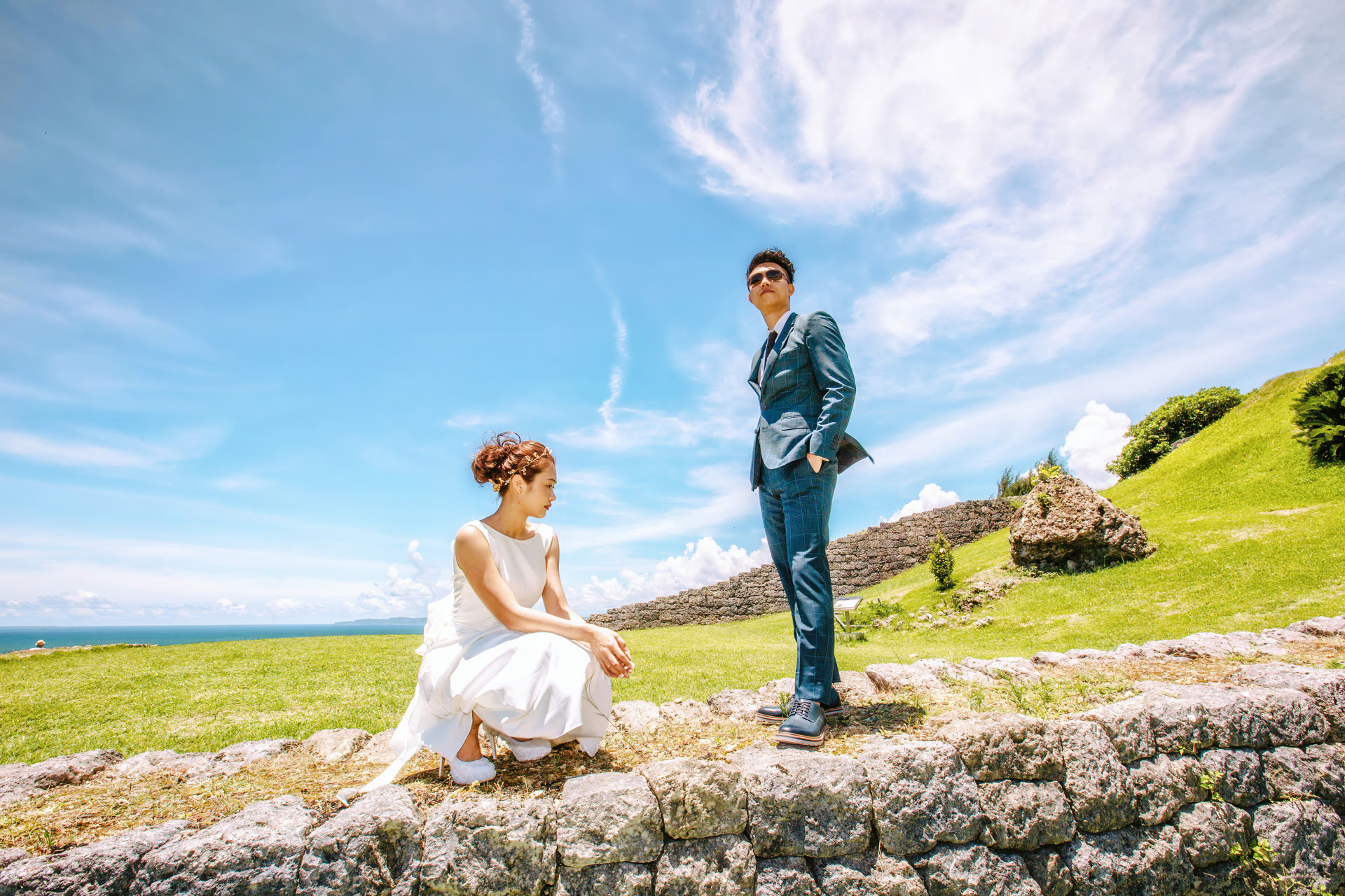 Couple on a coastal terrace in Okinawa, bride in a white gown