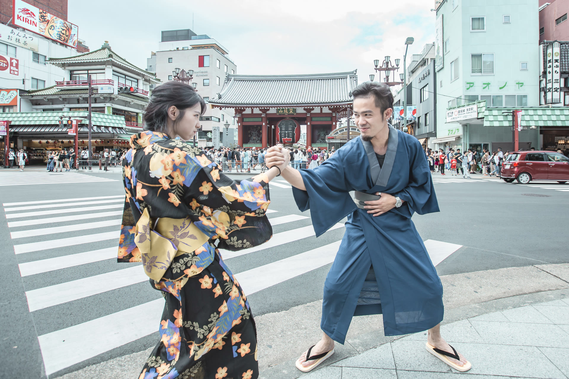 Couple in kimono on a crossing near Senso-ji temple in Asakusa