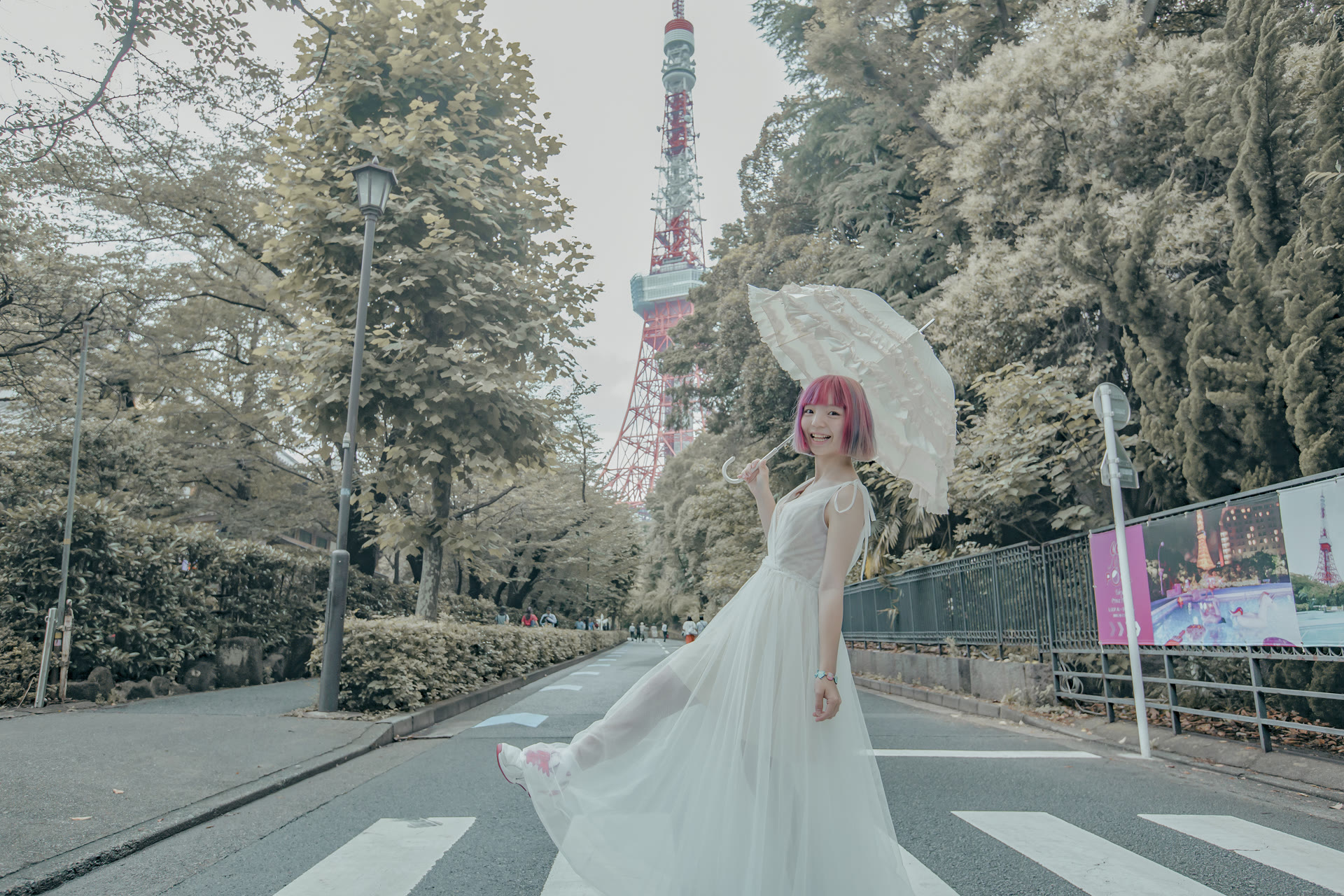 Bride with a lace parasol on a crossing beneath Tokyo Tower
